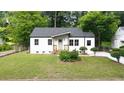 Beautiful renovated home with modern windows, gray roof, white siding, and a well-manicured lawn at 1111 Edgefield Sw Dr, Atlanta, GA 30310