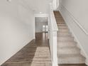 Inviting entryway with wood floors and a carpeted staircase leading to the upper level at 208 Oak View Ln, Dallas, GA 30157