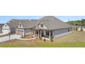 Beautifully designed single-Gathering home with lush landscaping and a driveway at 1609 Tielman Way, Snellville, GA 30078