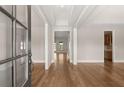 Elegant foyer with hardwood flooring and views into the living spaces and kitchen at 1609 Tielman Way, Snellville, GA 30078