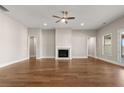 Spacious living room featuring a fireplace and modern ceiling fan at 1609 Tielman Way, Snellville, GA 30078