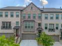 Charming townhome exteriors with brick facade, inviting entrances, and well-maintained landscaping at 3 Hundley Ln, Roswell, GA 30076