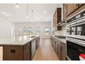 Modern kitchen features an island, stainless steel appliances, sleek countertops and ample cabinet space at 3772 Tielman St, Snellville, GA 30078