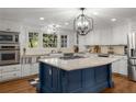 Bright, remodeled kitchen featuring a large island, granite countertops, and white cabinetry at 6990 Brandon Mill Nw Rd, Atlanta, GA 30328