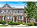 Charming townhouse featuring a well-maintained front yard with lush greenery and a welcoming entrance at 2281 Millhaven Se St # 18, Smyrna, GA 30080