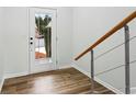 Bright entryway featuring wood floors, white walls, modern staircase, and a door with views of the outdoors at 326 Oakview Way, Canton, GA 30114