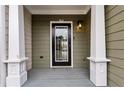 Inviting front porch with white columns and a black door, perfect for a cozy and stylish entrance at 326 Oakview Way, Canton, GA 30114