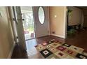 Inviting foyer with hardwood floors, a patterned rug, and natural light streaming in from the front door at 1833 Stephenson Rd, Lithonia, GA 30058