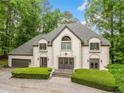Picture of the front exterior showcasing the roof, dormer windows, entrance, and landscaping at 550 Atlanta Country Club Se Dr, Marietta, GA 30067