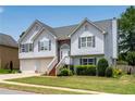 Charming two-story home with a two-car garage, stone accents, and a well-maintained lawn at 607 Lexington Way, Woodstock, GA 30189