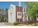 Traditional two-story brick and vinyl home with a covered front porch and landscaped front yard at 106 Weatherstone Square Drive, Woodstock, GA 30188