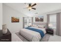 Tranquil main bedroom with neutral tones, a ceiling fan, and large windows at 106 Weatherstone Square Drive, Woodstock, GA 30188