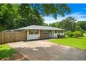Shot of the front of the house with a concrete driveway and manicured lawn showcasing the charming exterior at 3839 Brookcrest Cir, Decatur, GA 30032
