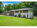 Beautiful house with a well-maintained lawn, white brick, and wood accents giving it a cozy and modern feel at 3839 Brookcrest Cir, Decatur, GA 30032