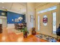 Bright foyer with hardwood floors, transom window, and view into dining area with blue accent wall at 410 Fitzgerald Ln, Fayetteville, GA 30215