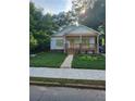 Charming one-story home featuring a welcoming front porch and lush green lawn at 1167 Oakland Sw Dr, Atlanta, GA 30310