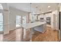 Modern kitchen features a large center island, stainless steel appliances, and ample cabinet space at 1575 Petal Nw Pt, Kennesaw, GA 30152