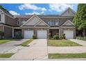 Well-kept townhomes showcasing individual one-car garages and manicured lawns in a tidy neighborhood setting at 2555 Flat Shoals Rd # 1405, College Park, GA 30349