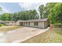 Spacious white brick home with a long driveway and a lush green lawn at 703 Alvis Ln, Norcross, GA 30093