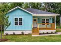 Charming light blue bungalow with a cozy front porch and newly landscaped front yard at 1317 Bernard Nw St, Atlanta, GA 30314
