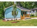 Charming light blue bungalow with a cozy front porch and newly landscaped front yard at 1317 Bernard Nw St, Atlanta, GA 30314
