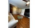 The living room features hardwood floors, neutral paint, a ceiling fan, and modern decor at 380 South St, Buford, GA 30518