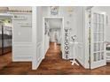 Inviting hallway with hardwood floors, decorative wainscoting, and a welcoming ambiance at 858 Red Rock Ct, Suwanee, GA 30024