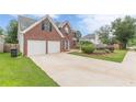 Traditional two-story brick home with a spacious driveway and landscaped front yard at 330 Kentwood Springs Dr, Hampton, GA 30228