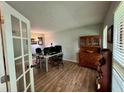Bright office space with wood-look floors, French doors, and natural light at 4506 Town Crier Sw Rd, Lilburn, GA 30047