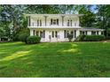 Two-story white home with a large, well-maintained lawn and a double-decker front balcony at 5290 River Mill Cir, Marietta, GA 30068