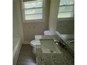 Bathroom with granite countertop vanity, toilet and tub and shower combination at 5924 Central Church Rd, Douglasville, GA 30135