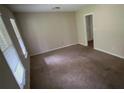 This bedroom features neutral walls, carpet flooring, and ample natural light at 5924 Central Church Rd, Douglasville, GA 30135