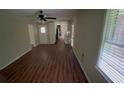 A combined living and dining area boasting wood flooring and large windows at 5924 Central Church Rd, Douglasville, GA 30135