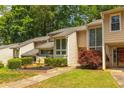 Charming townhome exterior with lush landscaping, green lawn, and direct walkway access at 2012 Variations Ne Dr, Atlanta, GA 30329