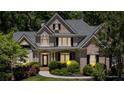 Charming brick home with manicured bushes, trimmed shrubbery and classic window shutters at 1311 Cobblemill Nw Way, Kennesaw, GA 30152