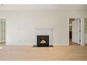 Open living area with hardwood floors and fireplace at 2921 Lenox Rd # 308, Atlanta, GA 30324