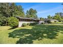 Well-maintained exterior with a lush green lawn and mature trees providing shade at 4020 N Cooper Lake Se Rd, Smyrna, GA 30082