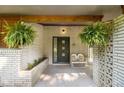 Inviting front porch with hanging ferns, seating, and decorative brickwork at 4020 N Cooper Lake Se Rd, Smyrna, GA 30082