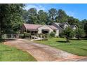 Ranch-style home featuring a driveway and accessible ramp leading to the front entrance at 437 Eastland Dr, Decatur, GA 30030