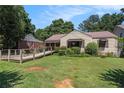 Attractive home with a green lawn and wooden ramp that provides accessibility to the front door at 437 Eastland Dr, Decatur, GA 30030