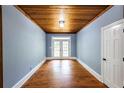 Spacious bonus room offers hardwood floors, a wooden ceiling, and doors to the backyard at 5780 Punkintown Rd, Douglasville, GA 30135
