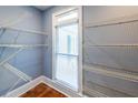 Spacious walk-in closet featuring built-in shelving and a window to allow in natural light at 5780 Punkintown Rd, Douglasville, GA 30135