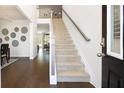 Bright entryway with dark hardwood flooring, stairway to the second floor, and views of other rooms at 1678 Lacebark Elm Way Way, Lawrenceville, GA 30045