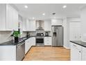Modern kitchen with stainless steel appliances, granite countertops, and white cabinets at 403 Defoors Mill Nw Dr, Atlanta, GA 30318