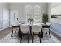 Elegant dining room with a wooden table, seating for six, and stylish decor at 1491 Black Hickory Pl, Norcross, GA 30093