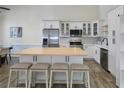 Bright kitchen featuring stainless steel appliances, white cabinetry, and a spacious island at 1491 Black Hickory Pl, Norcross, GA 30093