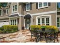 Inviting entrance with stone patio, seating, and well-maintained landscaping at 230 Bristol Stone Ct, Johns Creek, GA 30005