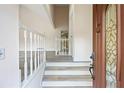 Bright foyer with light-colored steps, wood-look flooring, and clear view to open-concept living area at 3032 Ross Rd, Snellville, GA 30039