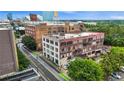 An aerial view showcases the commercial buildings, trees, adjacent street, and surrounding cityscape at 434 Marietta St Nw # 401, Atlanta, GA 30313
