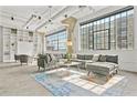 Bright living room featuring large windows, exposed ductwork, modern furnishings, and industrial-chic design at 434 Marietta St Nw # 401, Atlanta, GA 30313